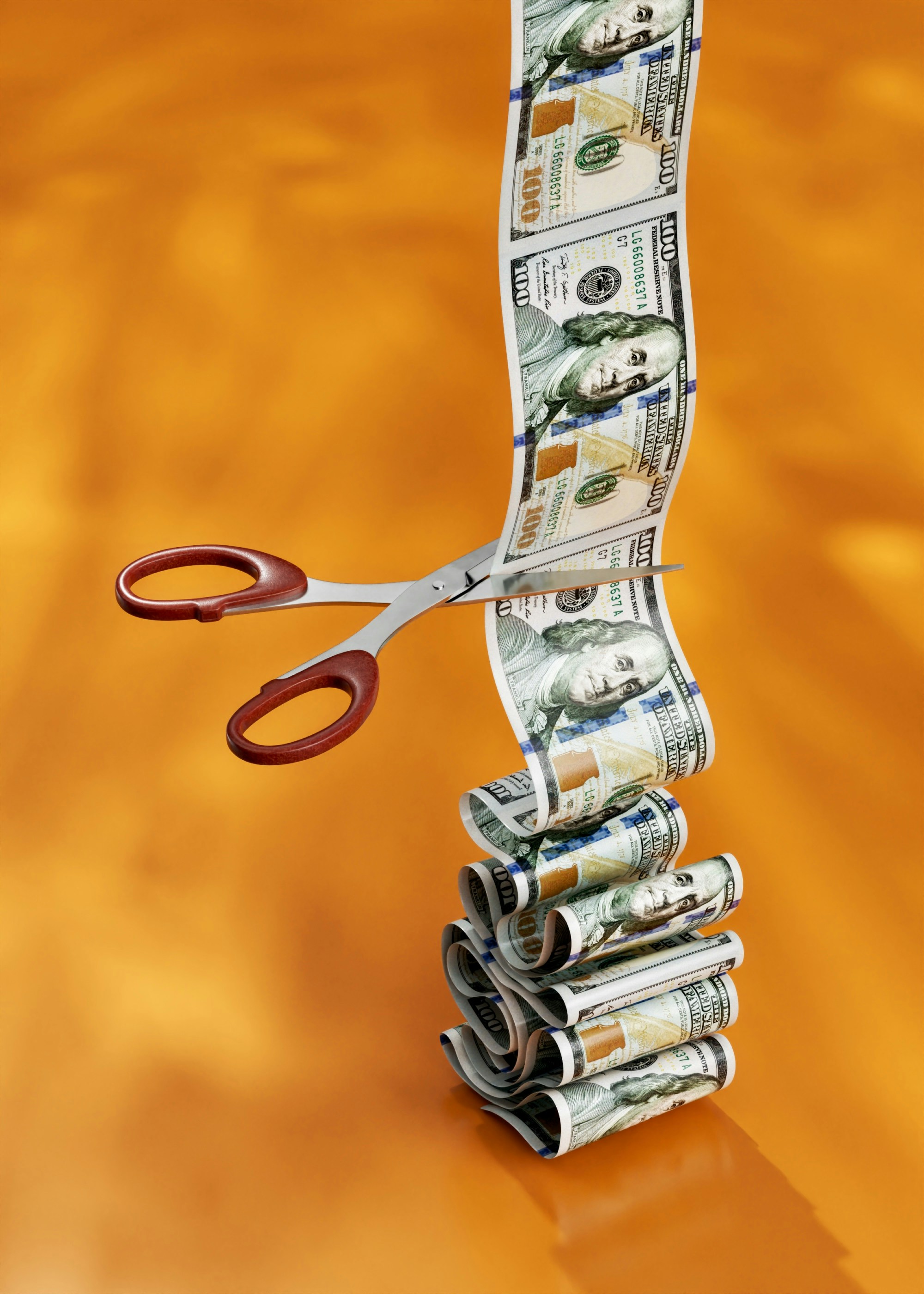 Unlimited stream of money is being cut with the office scissors
